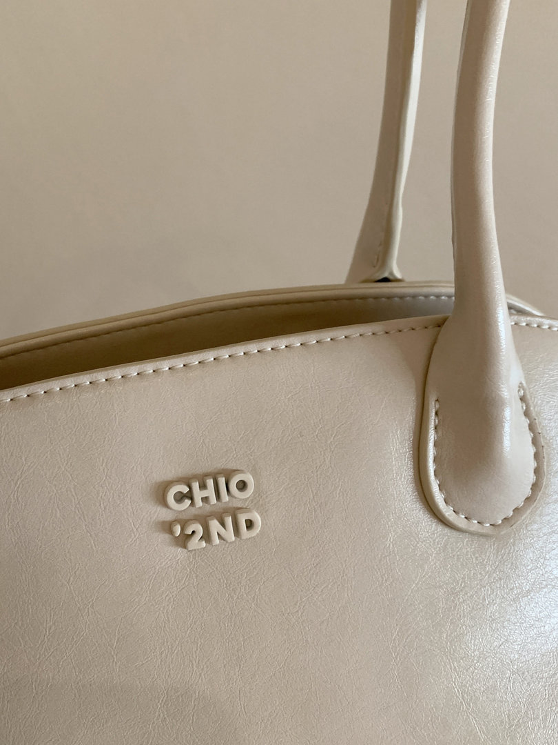 Beige leather handbag with shoulder straps and logo detail