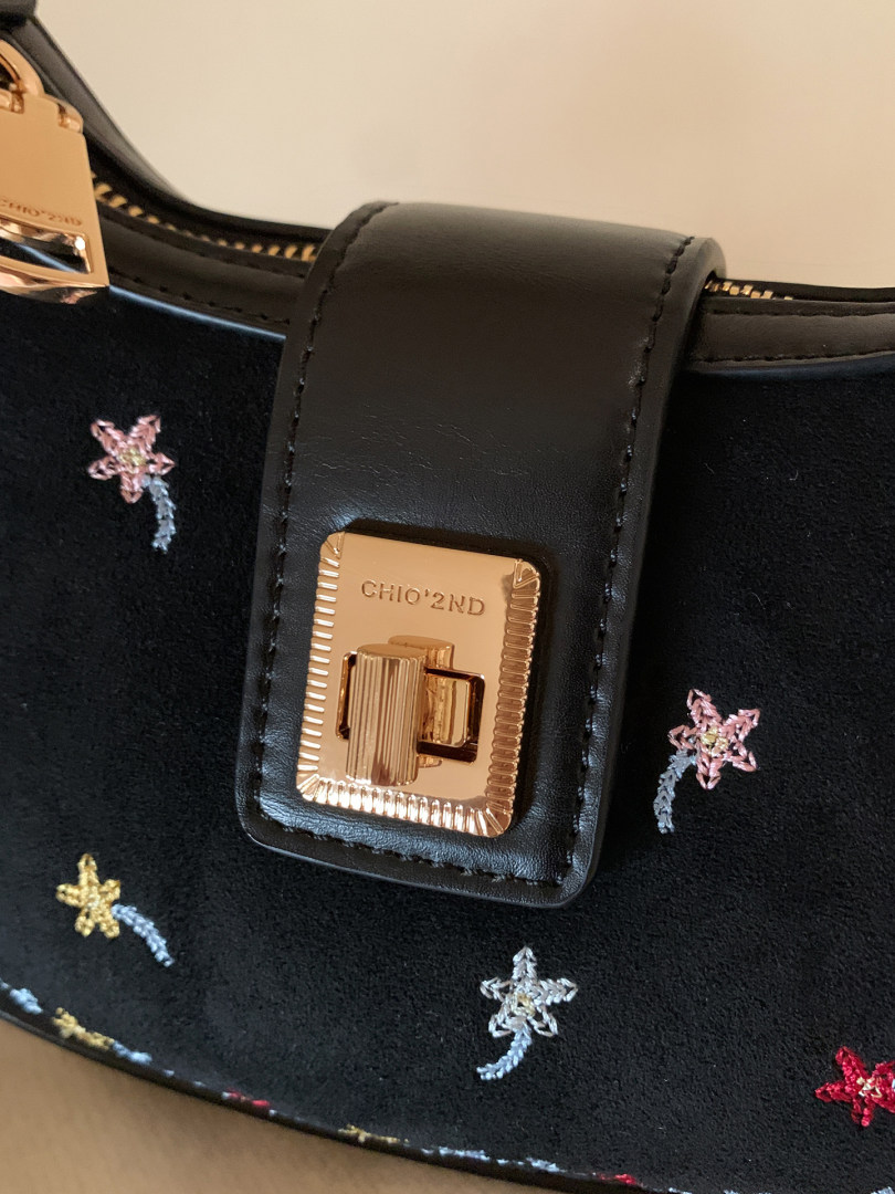 Black leather handbag with gold clasp and star embroidery