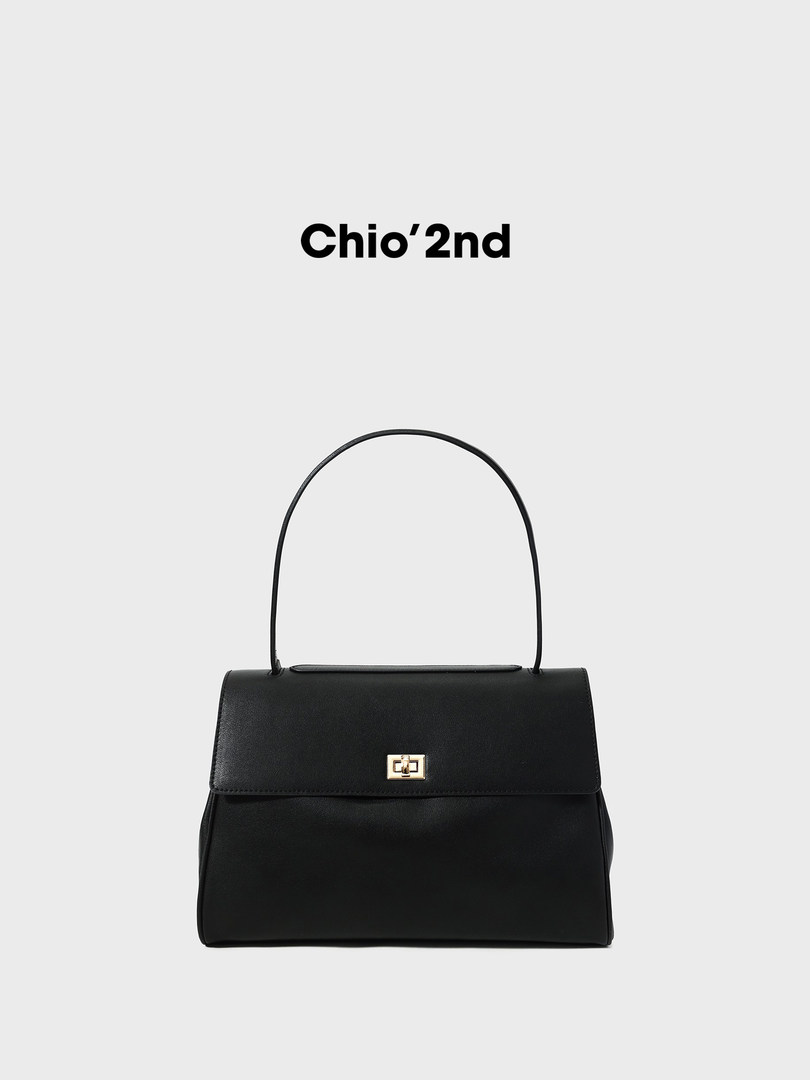 Black structured handbag with a gold clasp and top handle