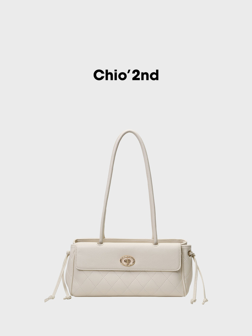 Cream quilted tote handbag with long handles on a white background