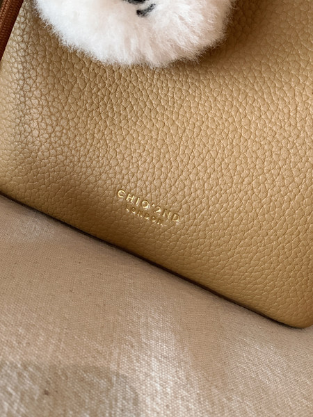 Close-up of a tan leather handbag interior with embossed Chloe London branding