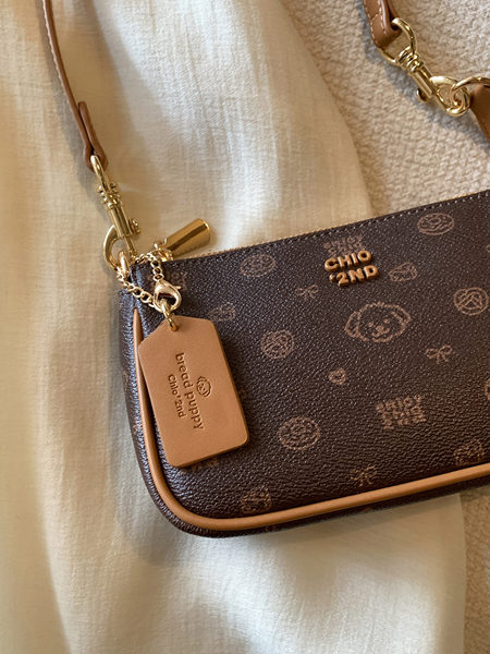 Brown monogram mini shoulder bag with gold hardware and logo tag