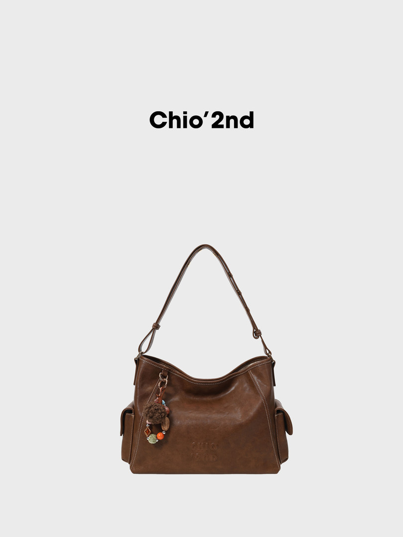 Brown leather shoulder handbag on a white background