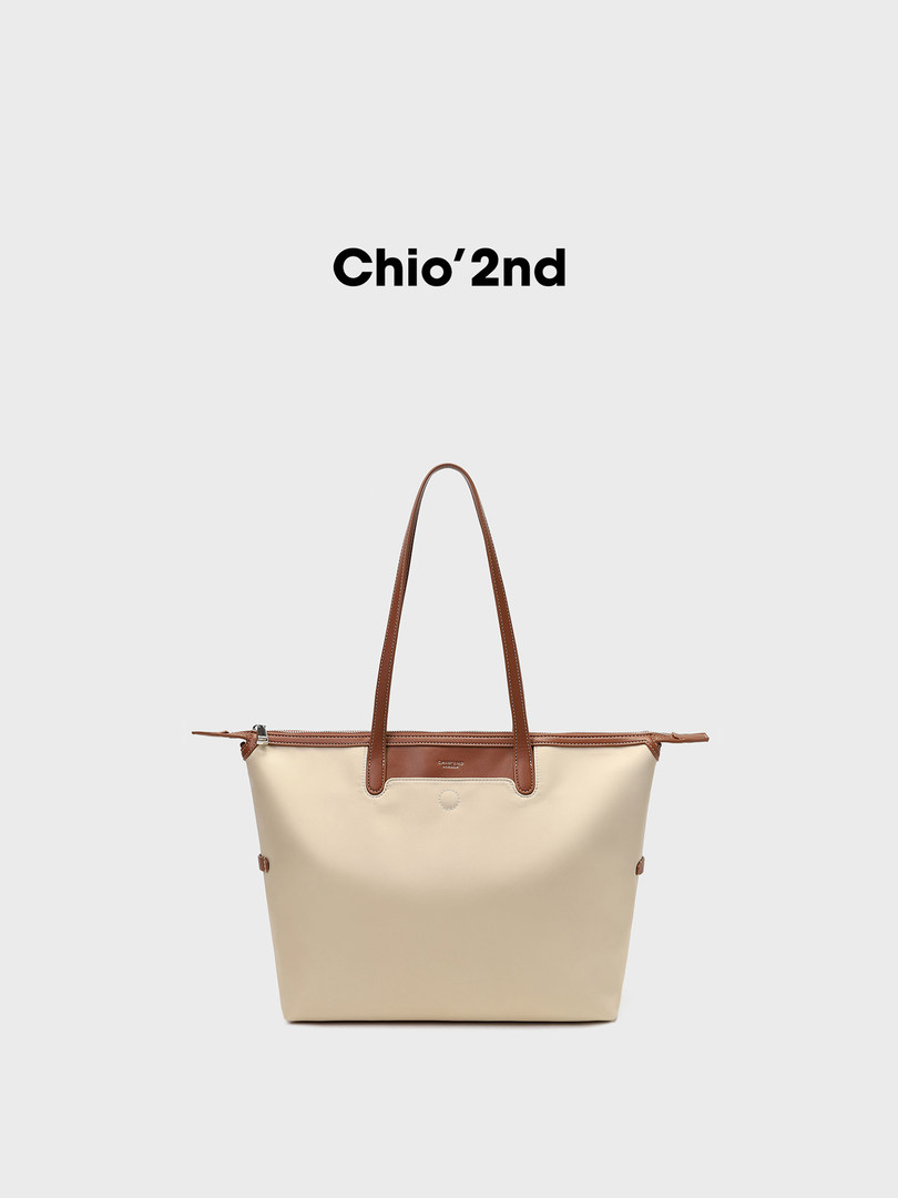 Beige tote bag with brown handles on a white background