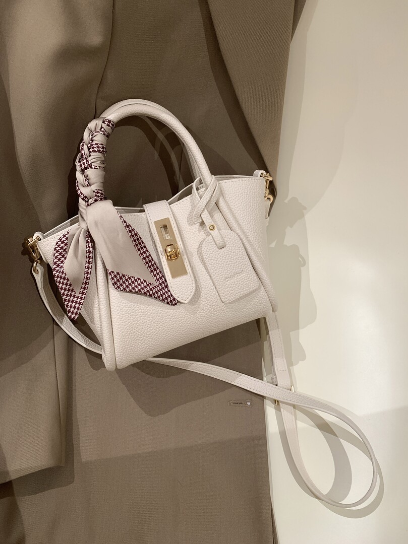 White leather handbag with patterned scarf detail and gold hardware