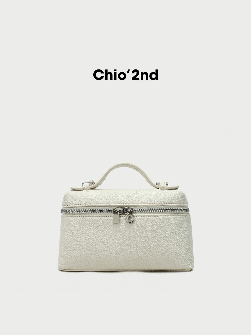 White structured zip-top handbag with top handle on a plain background