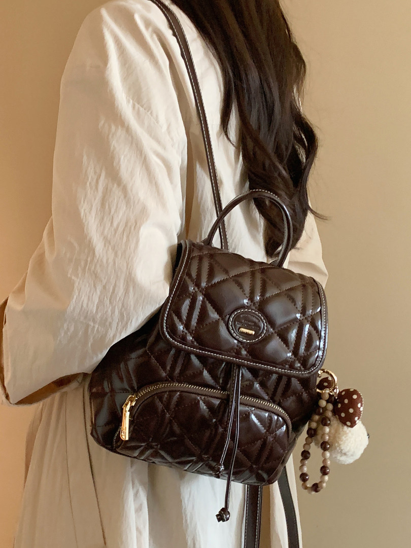 Brown quilted backpack worn by a person