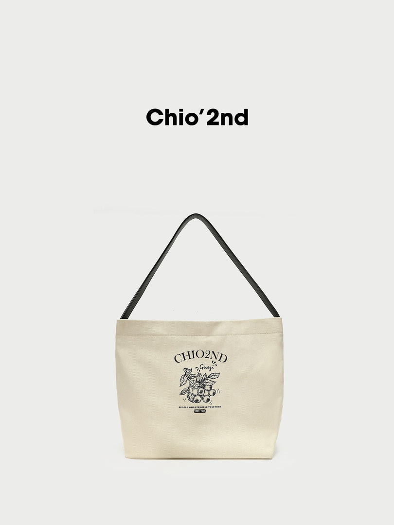Beige canvas tote bag with black handles and printed logo on a white background