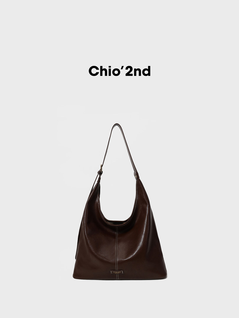 Brown leather shoulder bag on white background