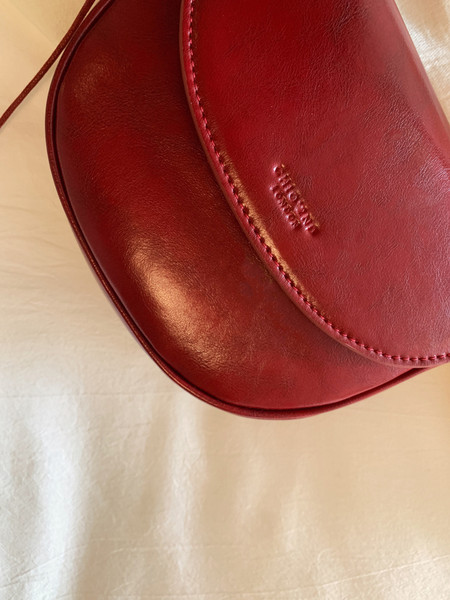 Red leather handbag close-up on a light background