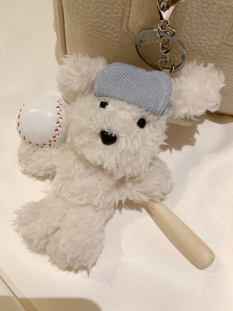 Plush teddy bear keychain with baseball and bat charm