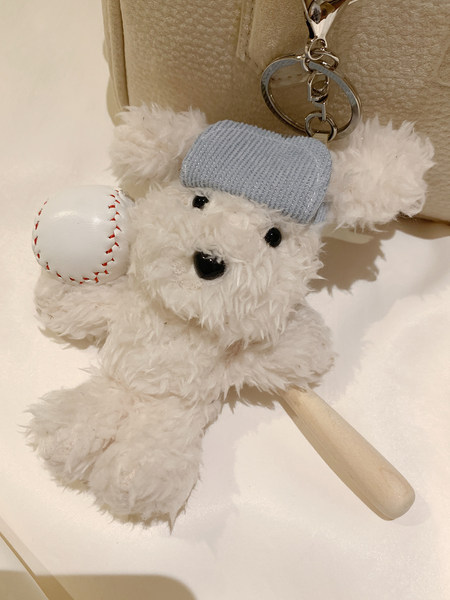 Plush teddy bear keychain with baseball and bat charm