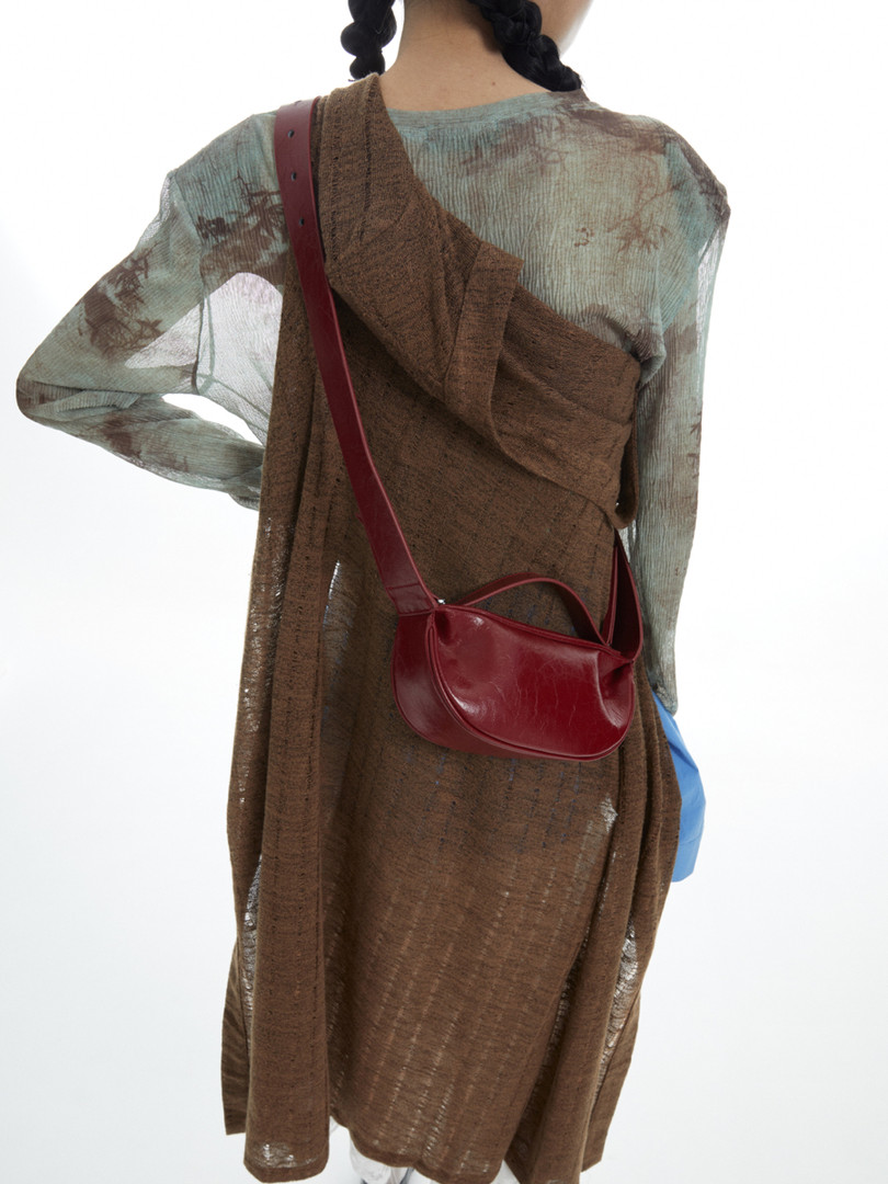 Sheer brown layered dress worn on a model with a red crossbody bag