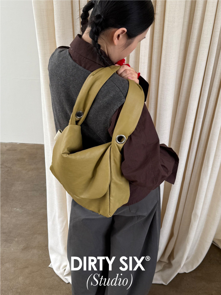 Olive green slouchy shoulder bag worn by a model