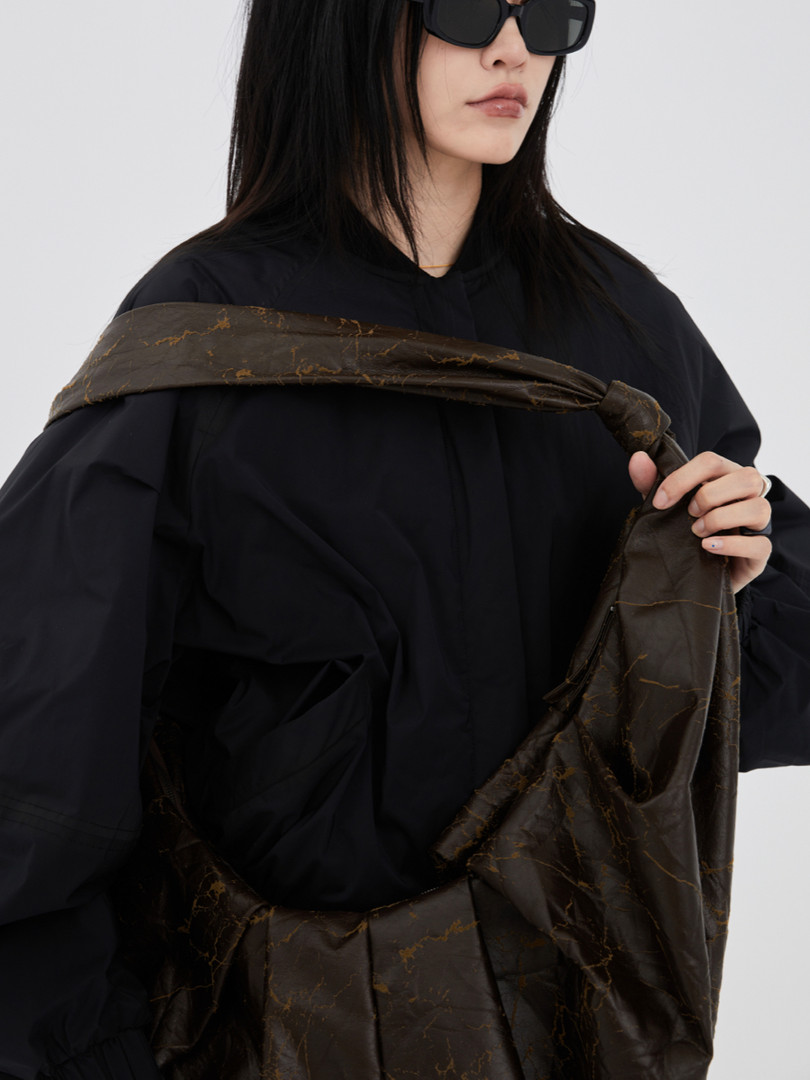 Brown patterned scarf worn by a model