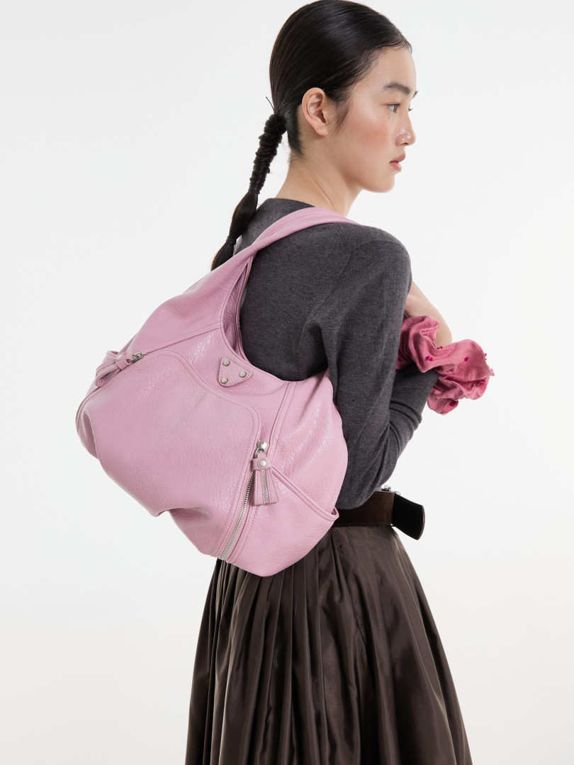 Pink leather backpack handbag worn on a model