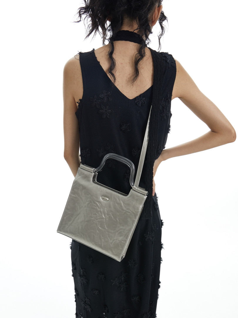 Silver shoulder handbag worn by a model