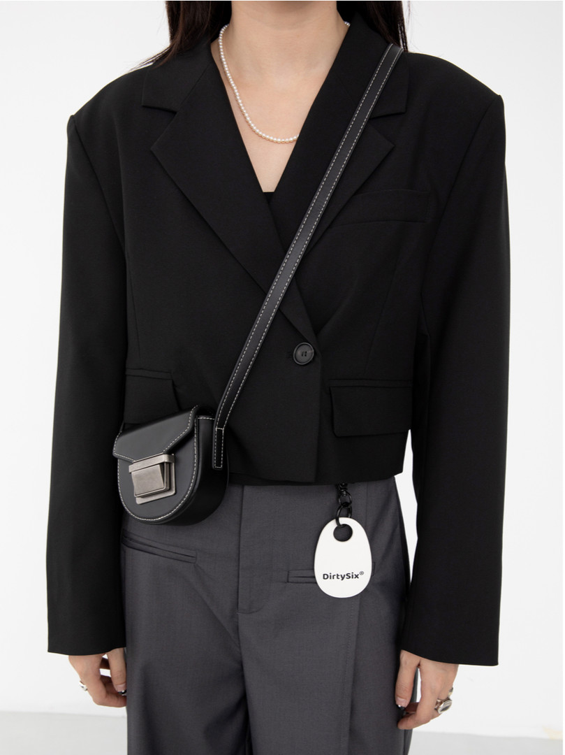 Black cropped blazer with a crossbody bag worn by a model