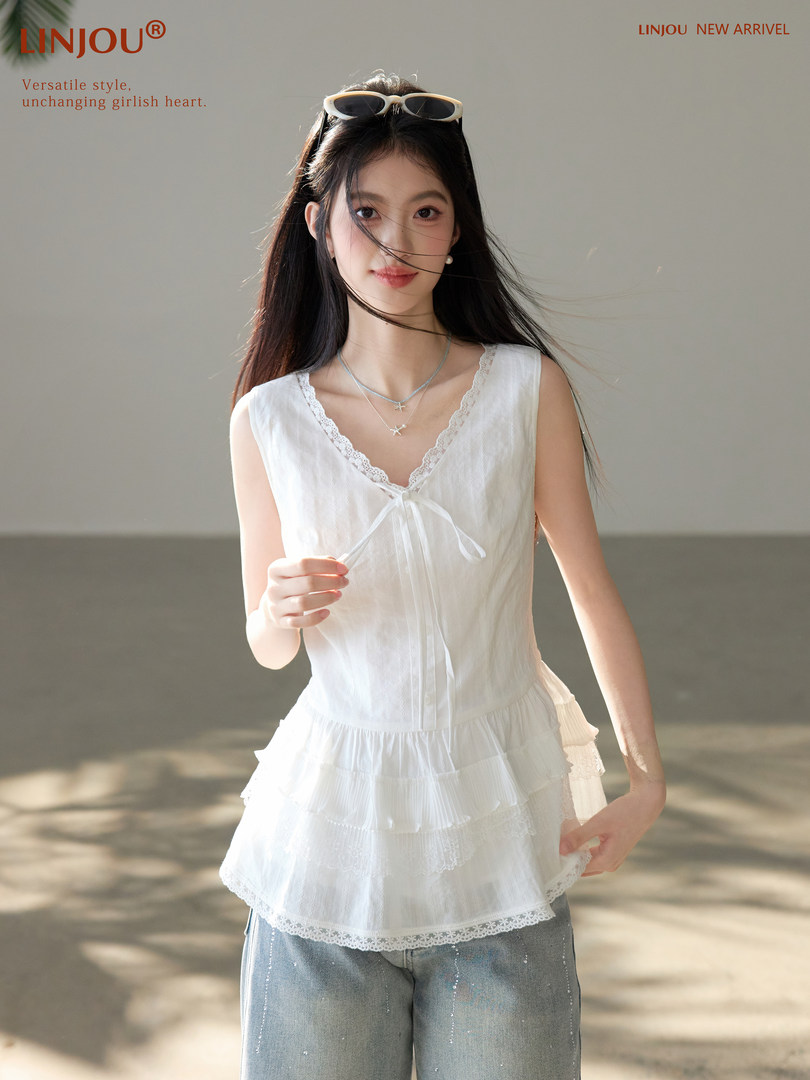Model wearing a white lace-trim sleeveless camisole top