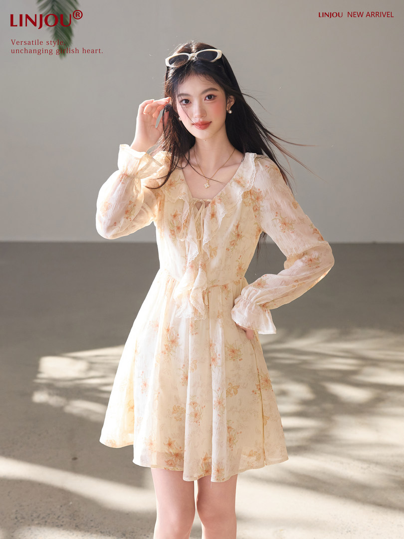 Model wearing a light floral long-sleeve mini dress