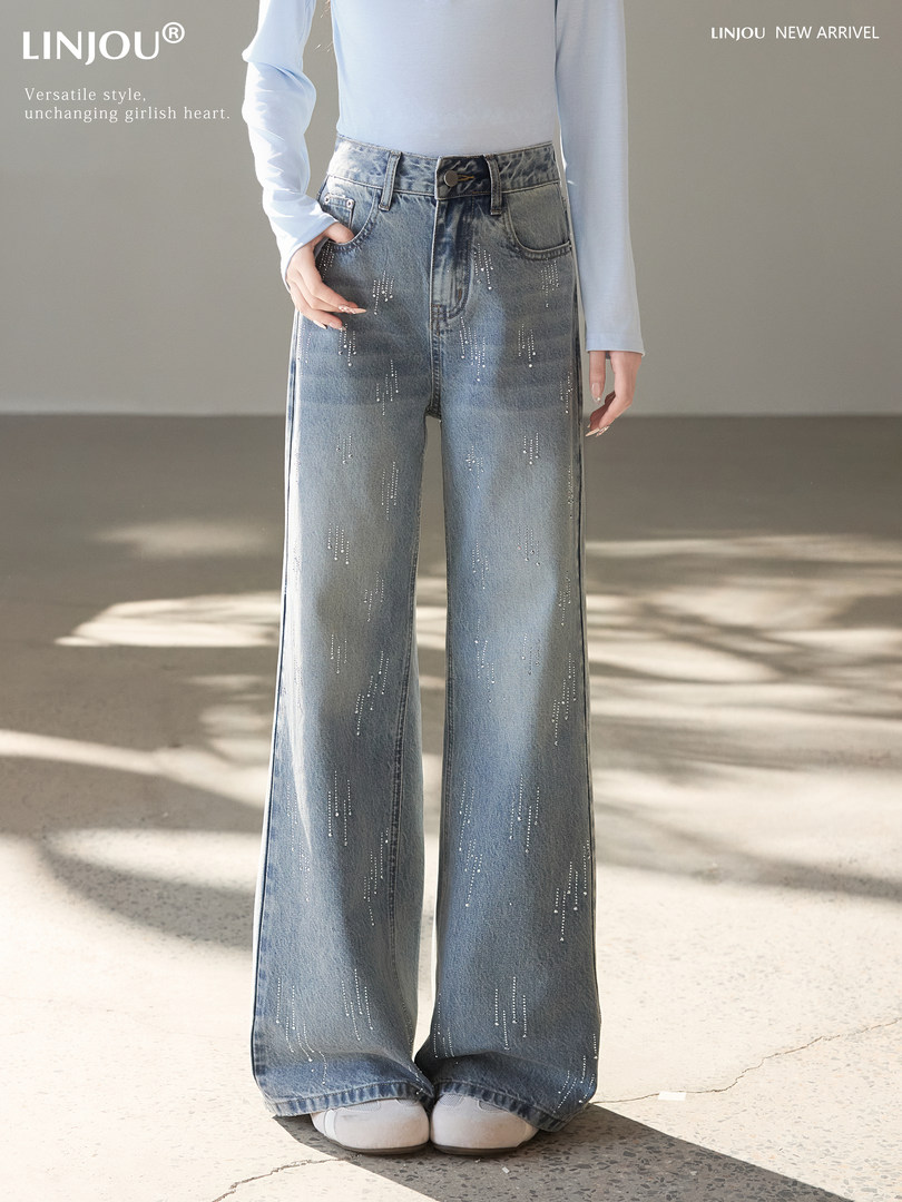 Model wearing light blue wide-leg embellished jeans