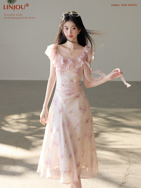 Pink floral ruffle dress worn by a model