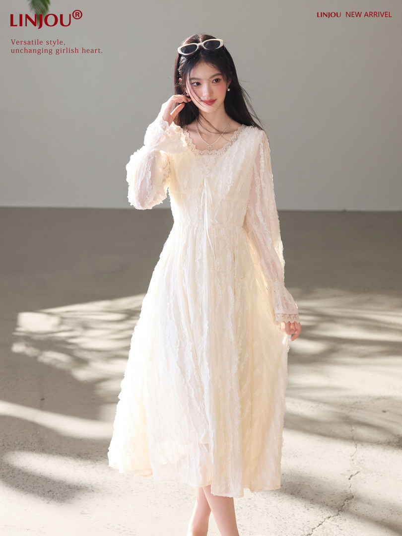 Model wearing a cream lace long-sleeve dress