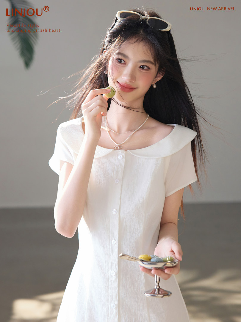 Woman wearing a white short-sleeve button-front dress