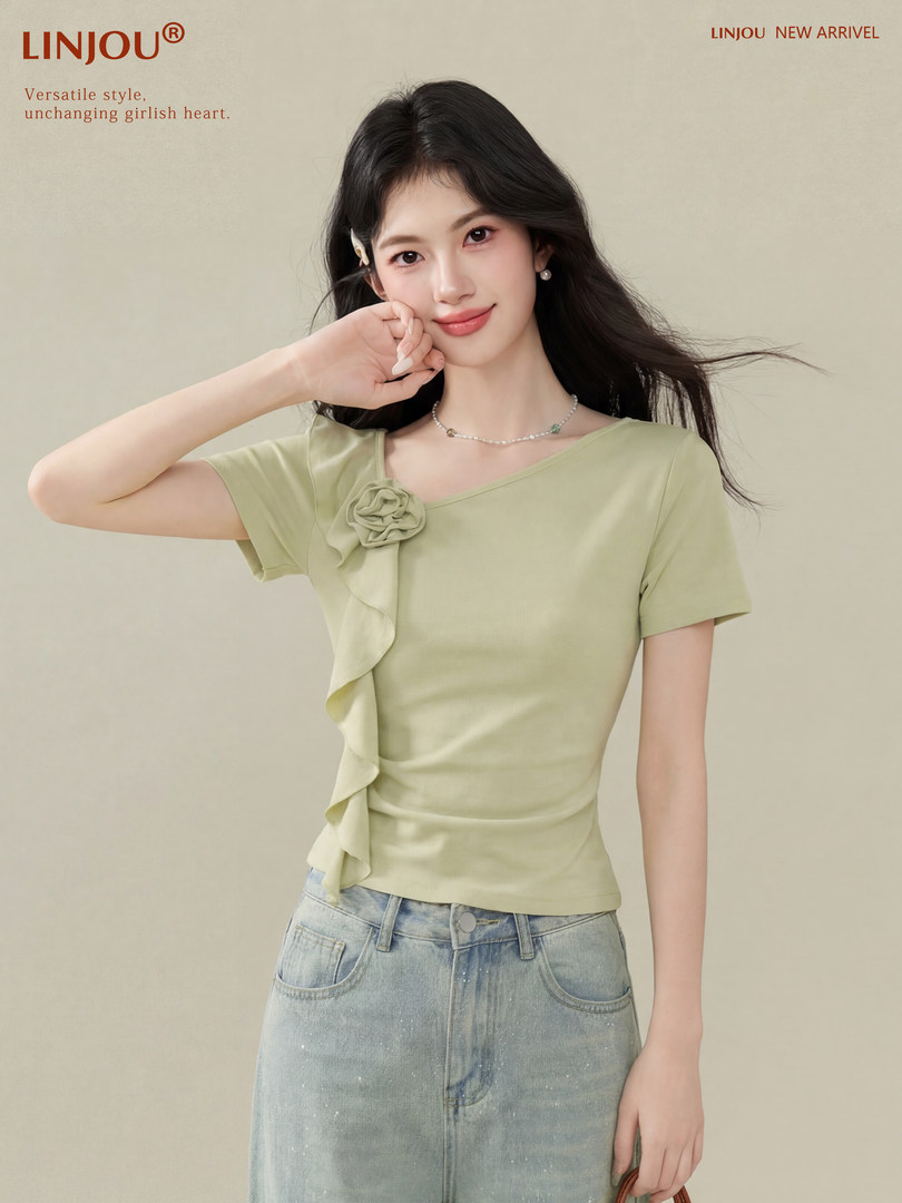 Woman wearing a light green short-sleeve ruffled top with jeans