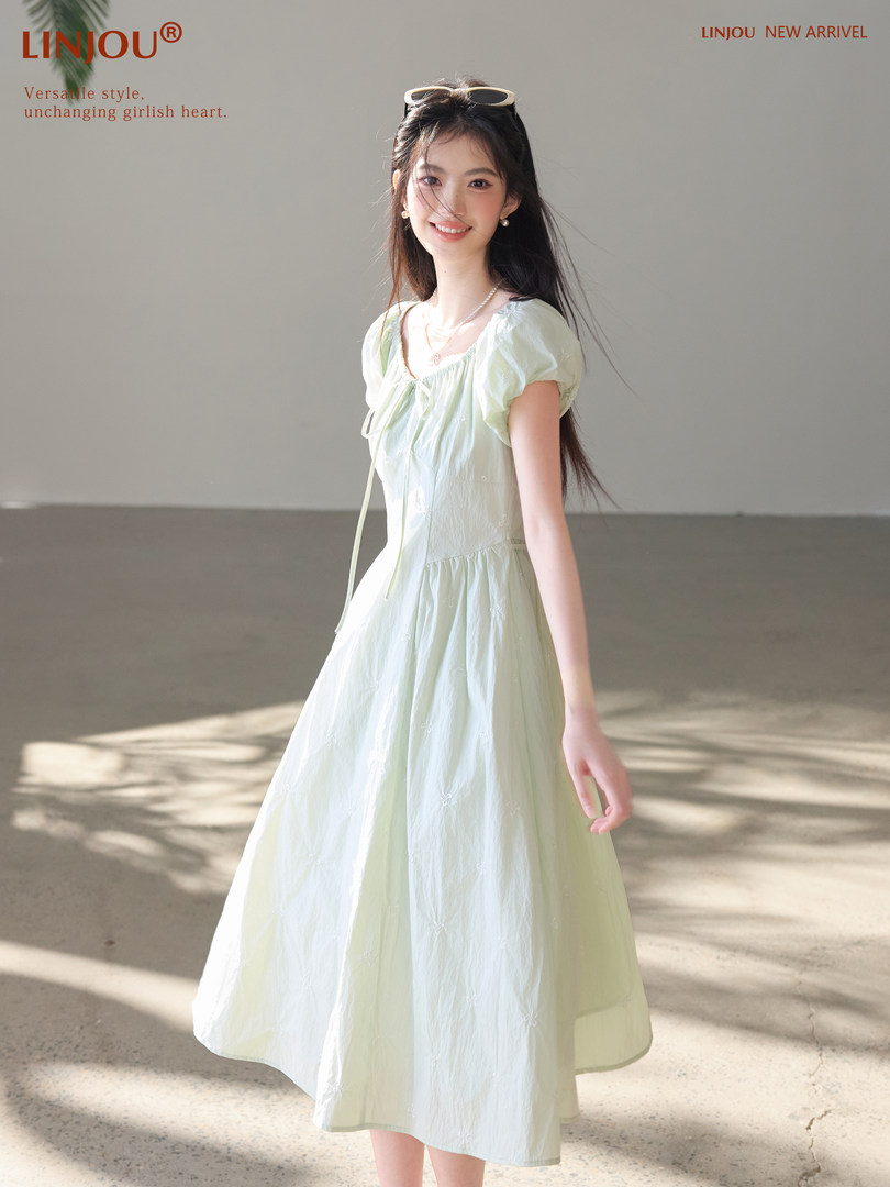 Model wearing a light mint puff-sleeve midi dress
