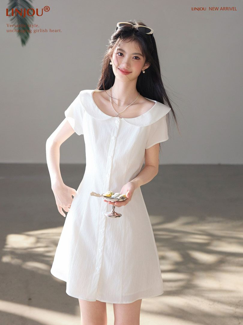 White short-sleeve button-front dress worn by a model