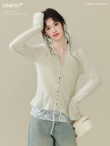 Model wearing an ivory lace-trim cardigan with jeans and a small quilted handbag