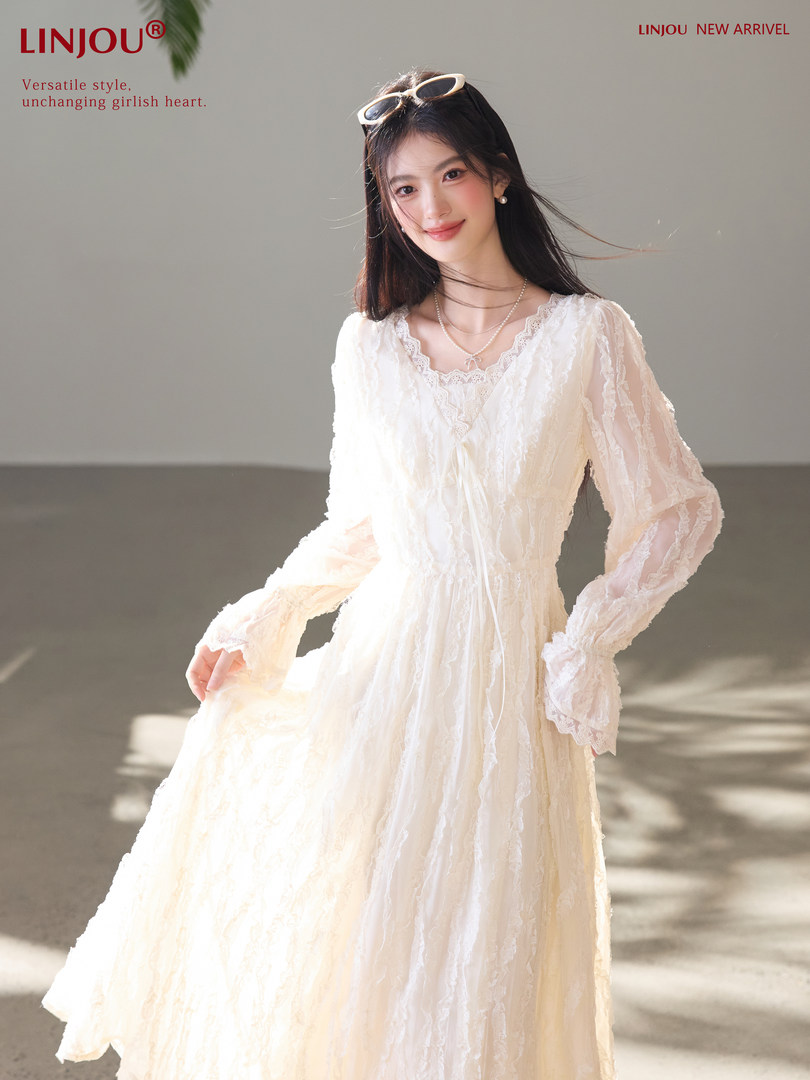 Model wearing a cream lace long-sleeve dress