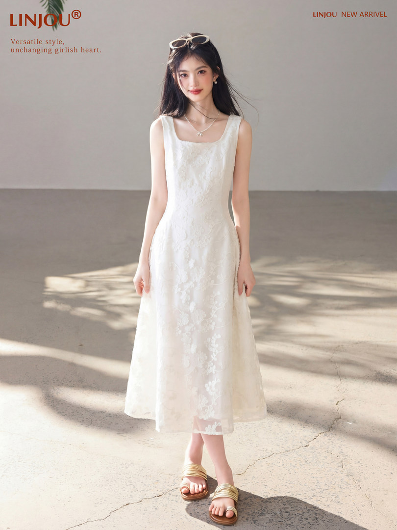 Woman wearing a white sleeveless floral midi dress