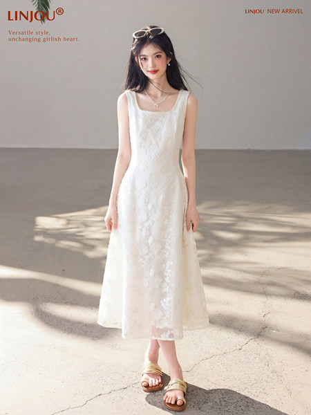 Woman wearing a white sleeveless floral midi dress