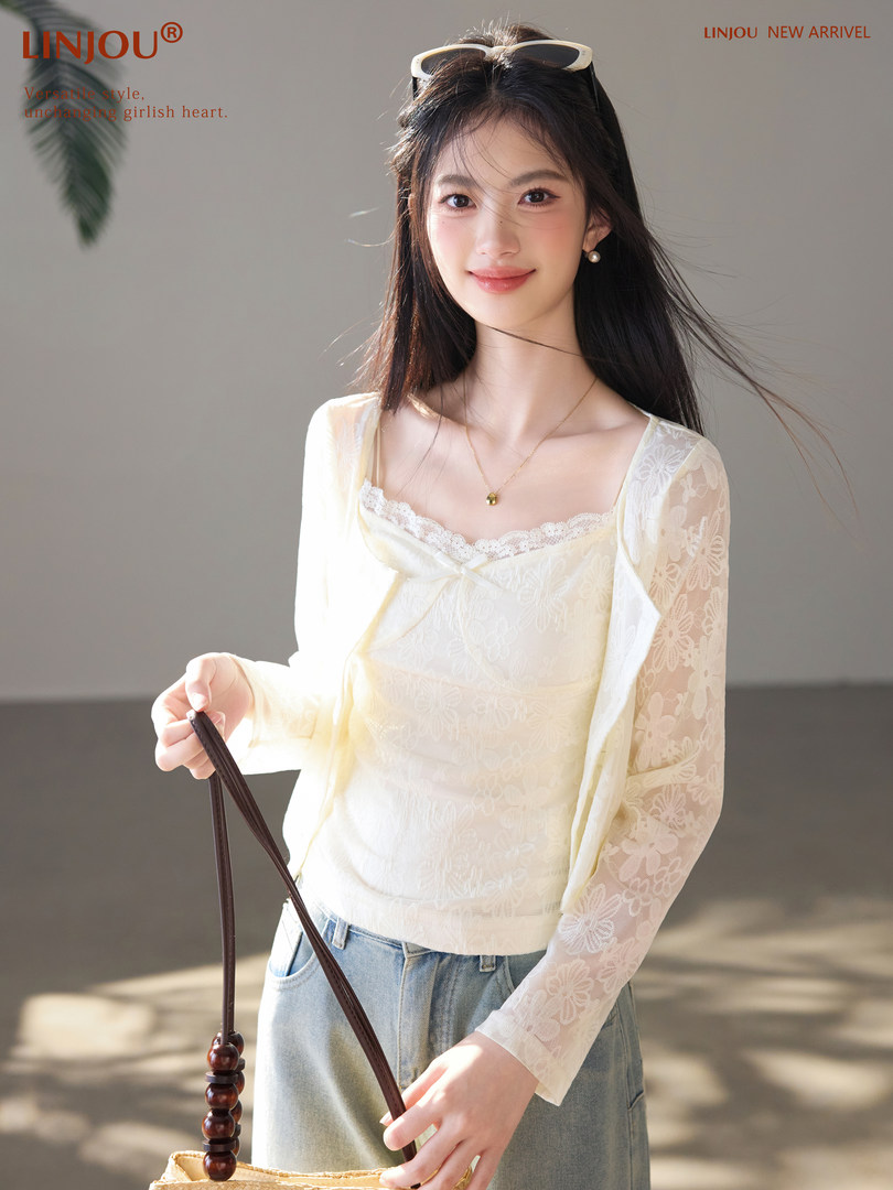 Woman wearing a cream lace long-sleeve top with a square neckline