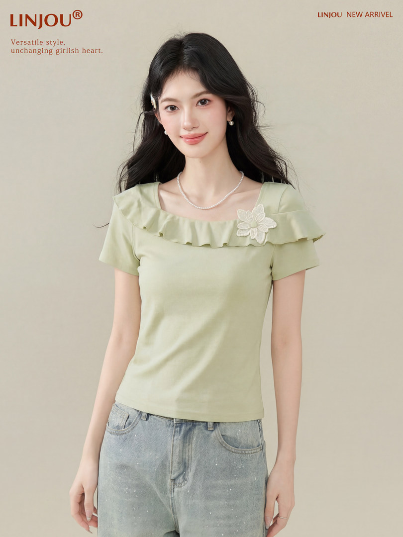 Model wearing a light green ruffle off-shoulder short-sleeve top