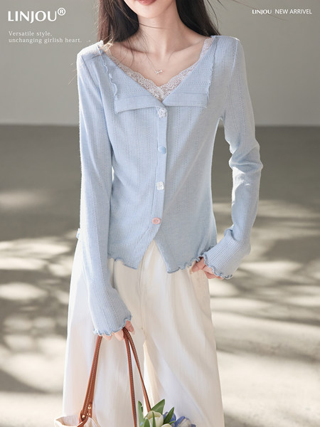 Light blue button-front cardigan worn over a lace-trim camisole on a model