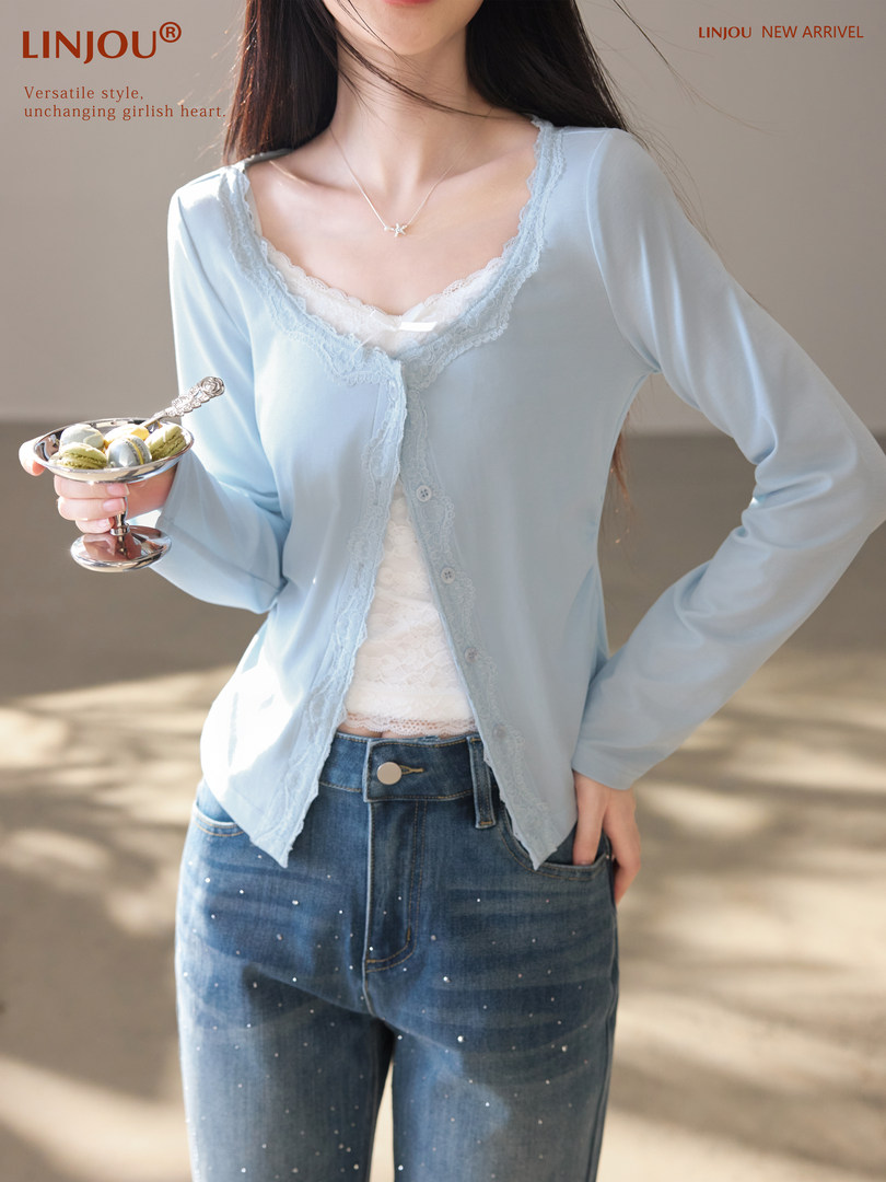 Light blue lace-trim cardigan worn over a camisole with jeans