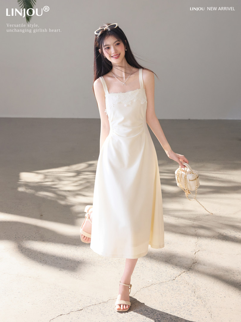 Model wearing a white sleeveless midi dress with a soft feminine look