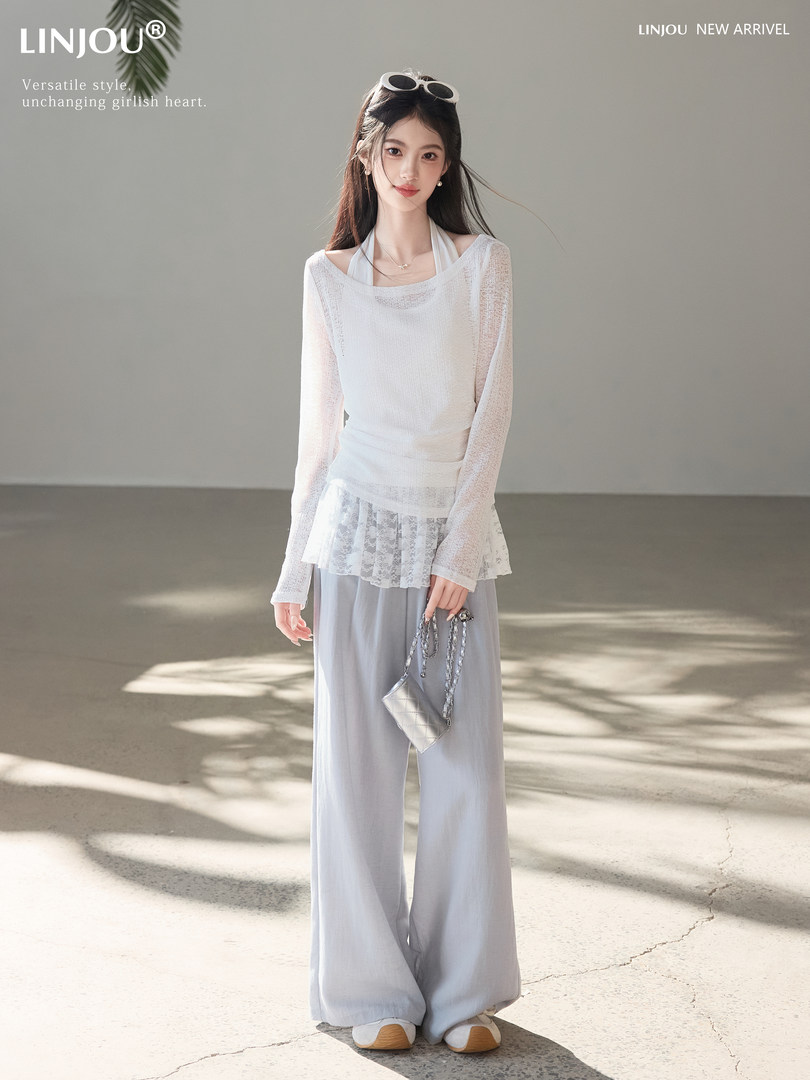 Model wearing a white sheer long-sleeve top with light gray wide-leg pants