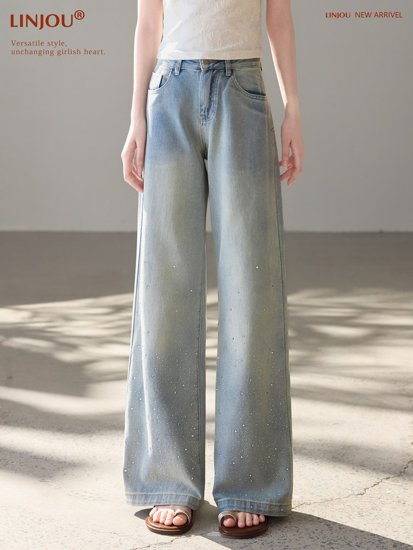 Model wearing light blue wide-leg denim jeans with subtle embellishments