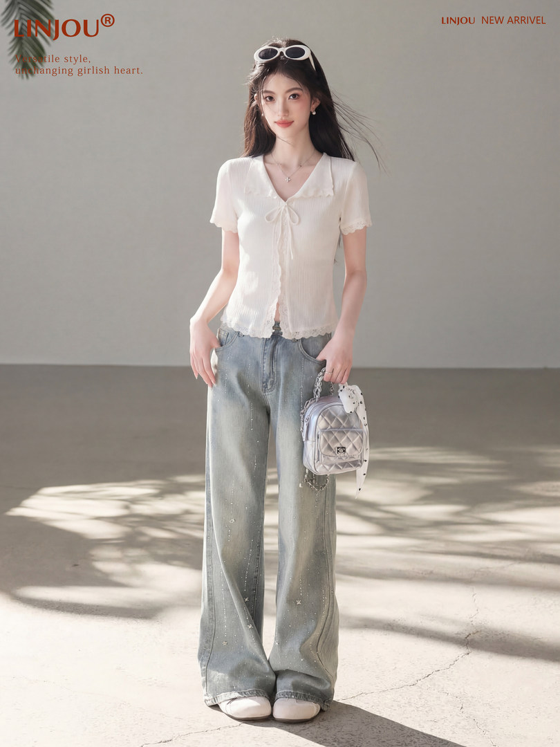 Model wearing a white short-sleeve tie-front blouse with wide-leg jeans and a small backpack