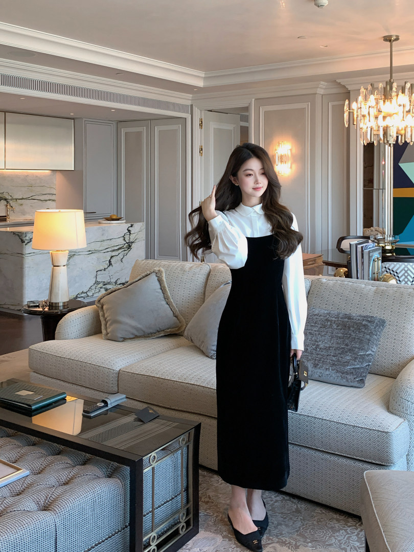 Woman wearing a black-and-white long-sleeve midi dress indoors