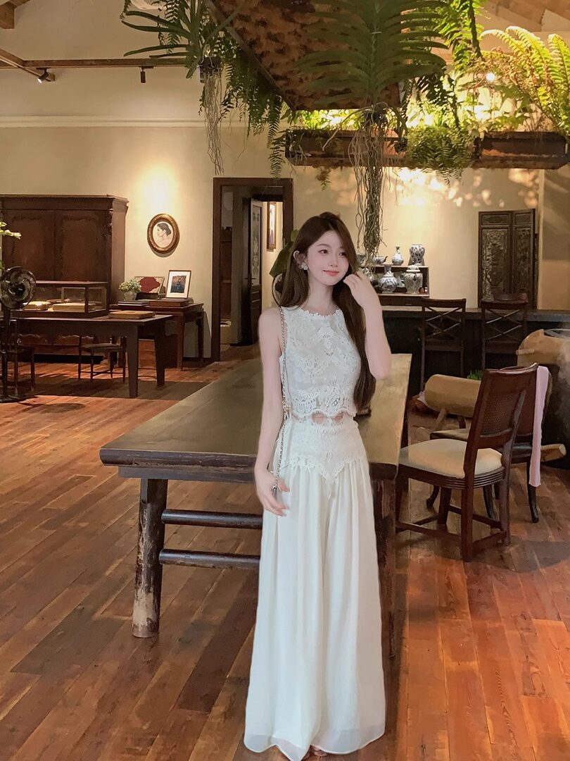 Woman wearing a white lace sleeveless maxi dress