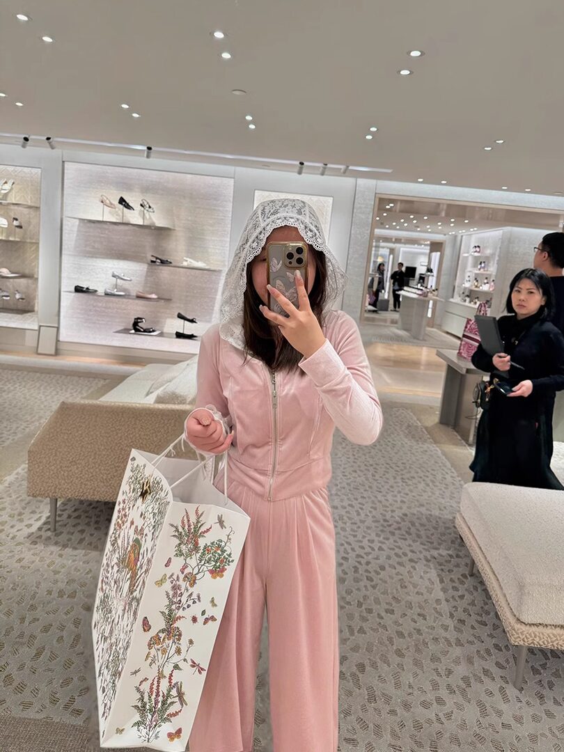 Pink matching loungewear set worn in a store mirror selfie