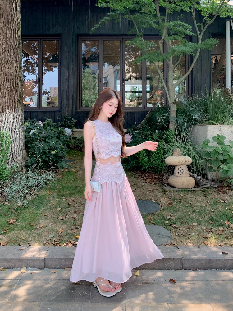 Model wearing a pastel pink lace and chiffon maxi dress outdoors