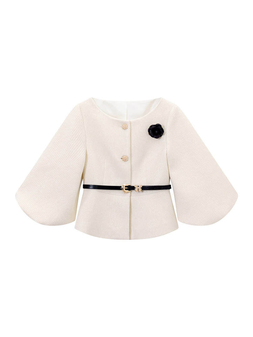 Cream long-sleeve textured jacket with black belt and floral brooch