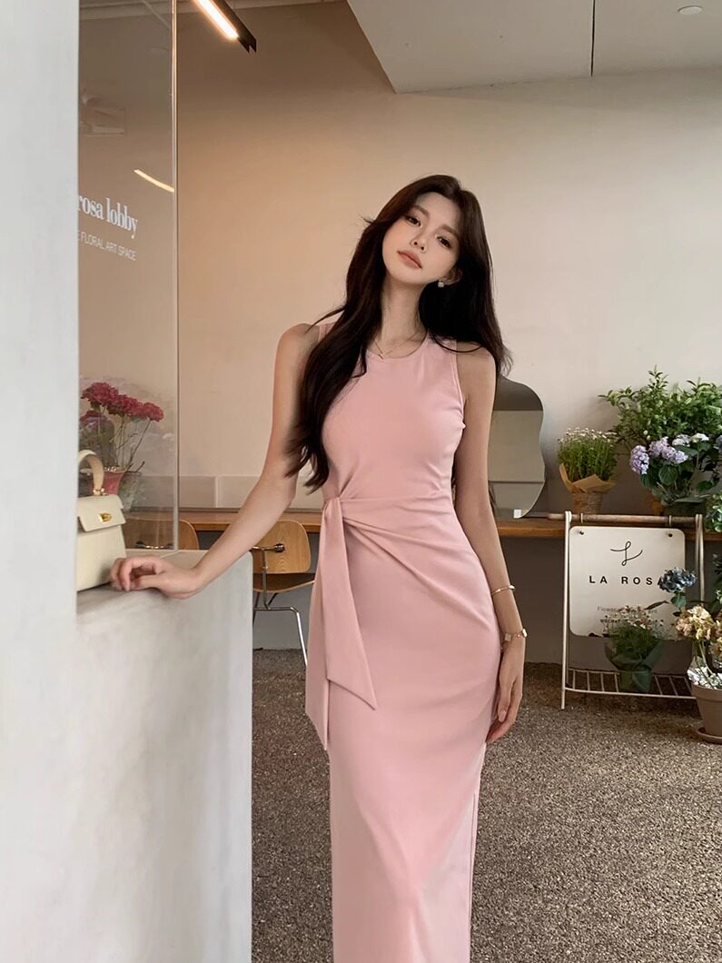 Pink sleeveless fitted maxi dress worn by a model