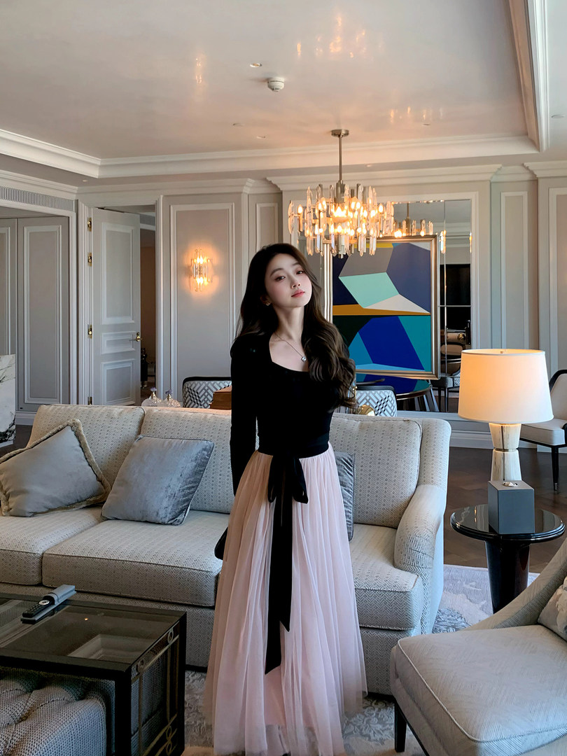 Model wearing a black long-sleeve top with a blush pink maxi skirt